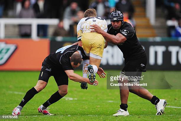 Hall Charlton and Filipo Levi of Newcastle stop Baptiste Hecker of Albi in his tracks during the Amlin Challenge Cup match between Newcastle Falcons...