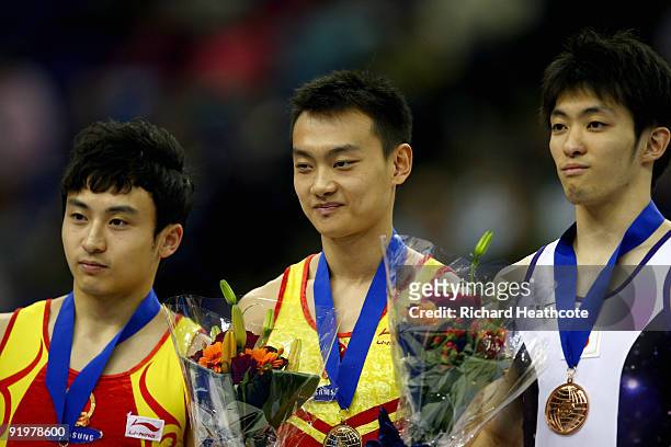 Guanyin Wang of China poses with his gold medal after he won the parallel bars during the Apparatus Finals on the sixth day of the Artistic...