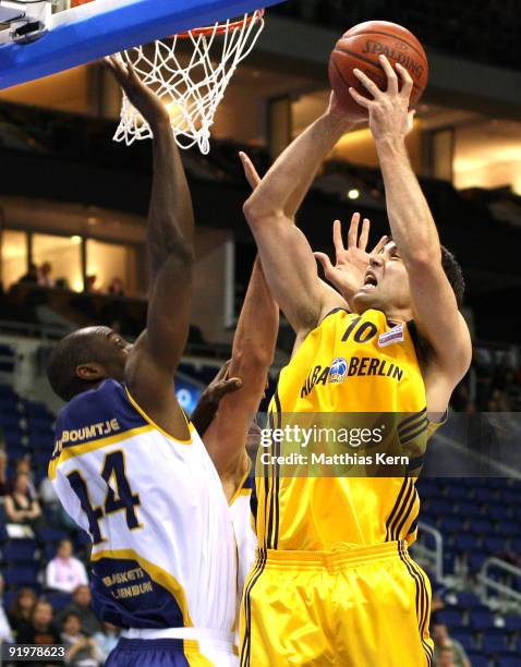 Blagota Sekulic of Berlin shoots as Ruben Boumtje Boumtje of Oldenburg defends during the Beko Basketball Bundesliga match between Alba Berlin and...