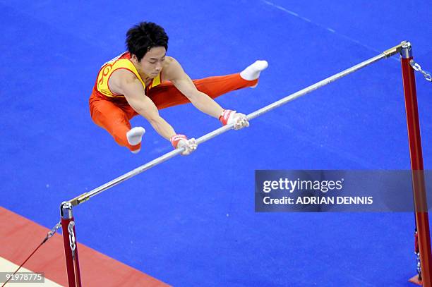 China's Zou Kai performs in the high bar event in the apparatus finals during the Artistic Gymnastics World Championships 2009 at the 02 Arena, in...