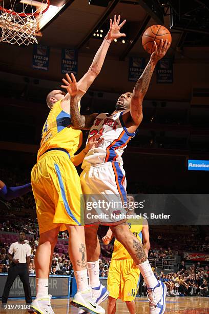 Wilson Chandler of the New York Knicks shoots against Maciej Lampe the Maccabi Electra Tel Aviv on October 18, 2009 at Madison Square Garden in New...