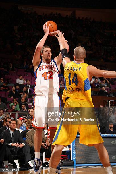 David Lee of the New York Knicks shoots against Maciej Lampe the Maccabi Electra Tel Aviv on October 18, 2009 at Madison Square Garden in New York...