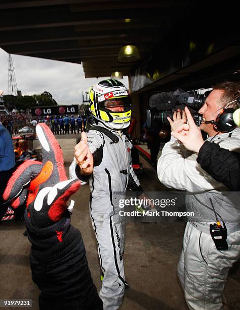 Jenson Button of Great Britain and Brawn GP celebrates in parc ferme after clinching the F1 World Drivers Championship during the Brazilian Formula...