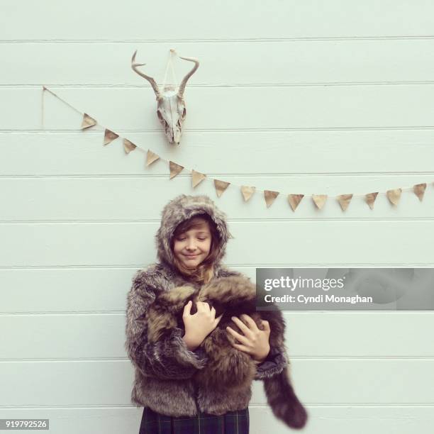 girl carrying maine coon cat - bunting white background fotografías e imágenes de stock