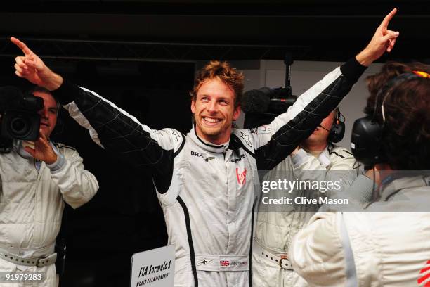 Jenson Button of Great Britain and Brawn GP celebrates in parc ferme after clinching the F1 World Drivers Championship during the Brazilian Formula...