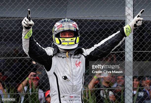 Jenson Button of Great Britain and Brawn GP celebrates in parc ferme after clinching the F1 World Drivers Championship during the Brazilian Formula...