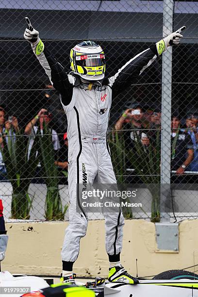 Jenson Button of Great Britain and Brawn GP celebrates in parc ferme after clinching the F1 World Drivers Championship during the Brazilian Formula...