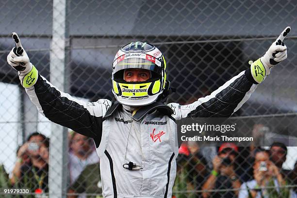 Jenson Button of Great Britain and Brawn GP celebrates in parc ferme after clinching the F1 World Drivers Championship during the Brazilian Formula...