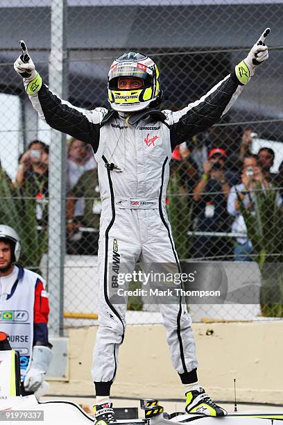Jenson Button of Great Britain and Brawn GP celebrates in parc ferme after clinching the F1 World Drivers Championship during the Brazilian Formula...