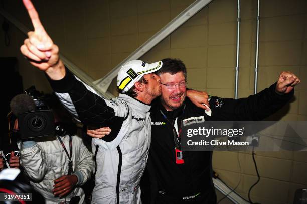 Jenson Button of Great Britain and Brawn GP is congratulated by Team Principal Ross Brawn after clinching the F1 World Drivers Championship during...