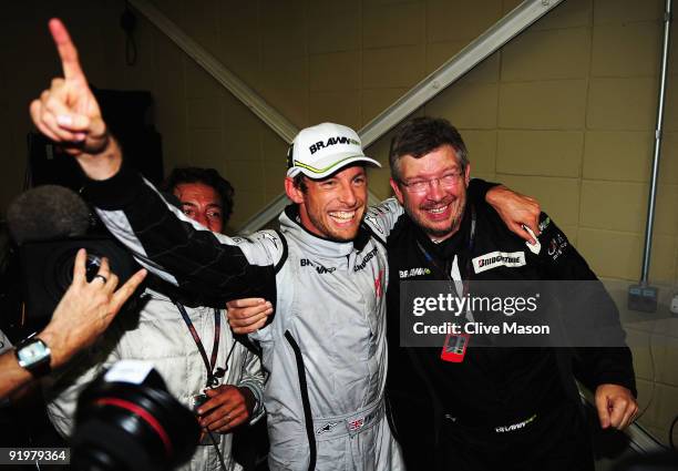 Jenson Button of Great Britain and Brawn GP is congratulated by Team Principal Ross Brawn after clinching the F1 World Drivers Championship during...