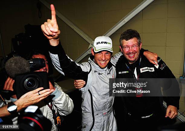 Jenson Button of Great Britain and Brawn GP is congratulated by Team Principal Ross Brawn after clinching the F1 World Drivers Championship during...