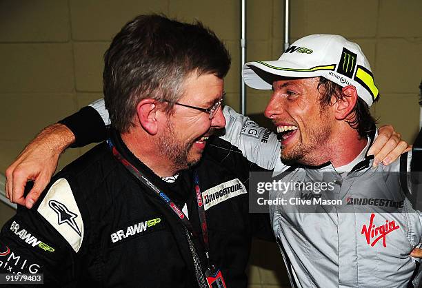 Jenson Button of Great Britain and Brawn GP is congratulated by Brawn GP Team Principal Ross Brawn after clinching the F1 World Drivers Championship...