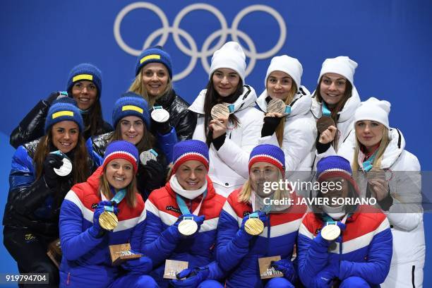 Sweden's silver medallists Anna Haag, Charlotte Kalla, Ebba Andersson and Stina Nilsson, Norway's gold medallists Ingvild Flugstad Oestberg, Astrid...