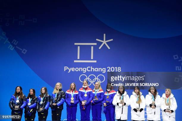 Sweden's silver medallists Anna Haag, Charlotte Kalla, Ebba Andersson and Stina Nilsson, Norway's gold medallists Ingvild Flugstad Oestberg, Astrid...