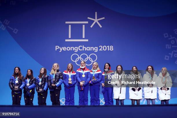 Silver medalists Anna Haag, Charlotte Kalla, Ebba Andersson and Stina Nilsson of Sweden, gold medalists Ingvild Flugstad Oestberg, Astrid Uhrenholdt...