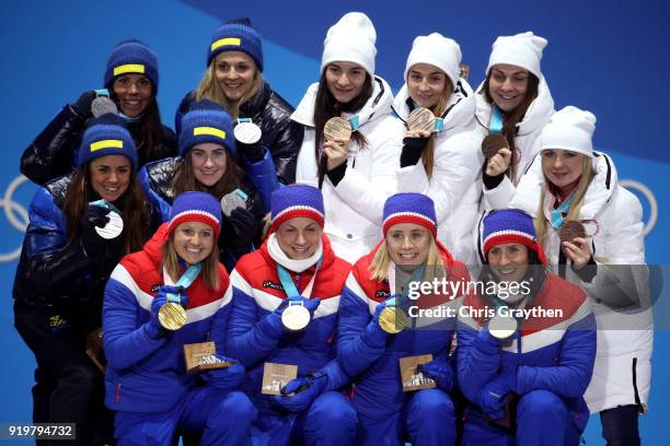 Silver medalists Anna Haag, Charlotte Kalla, Ebba Andersson and Stina Nilsson of Sweden, gold medalists Ingvild Flugstad Oestberg, Astrid Uhrenholdt...