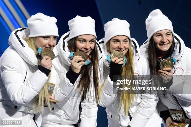 Russia's bronze medallists Natalia Nepryaeva, Yulia Belorukova, Anastasia Sedova and Anna Nechaevskaya pose on the podium during the medal ceremony...