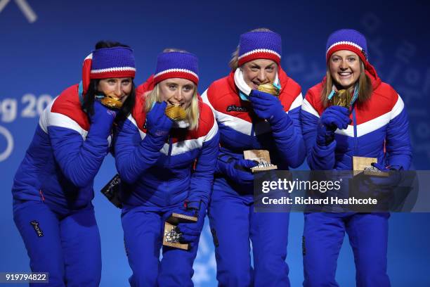 Gold medalists Ingvild Flugstad Oestberg, Astrid Uhrenholdt Jacobsen, Ragnhild Haga and Marit Bjoergen of Norway celebrate during the medal ceremony...