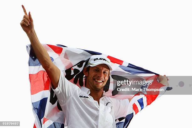 Jenson Button of Great Britain and Brawn GP celebrates clinching the F1 World Drivers Championship during the Brazilian Formula One Grand Prix at the...