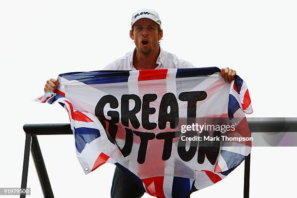 Jenson Button of Great Britain and Brawn GP celebrates clinching the F1 World Drivers Championship during the Brazilian Formula One Grand Prix at the...