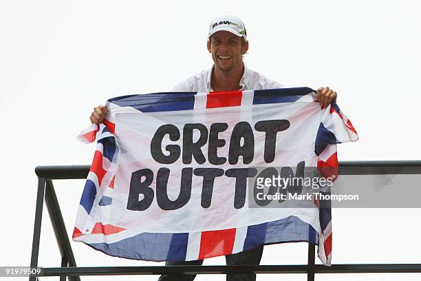 Jenson Button of Great Britain and Brawn GP celebrates clinching the F1 World Drivers Championship during the Brazilian Formula One Grand Prix at the...