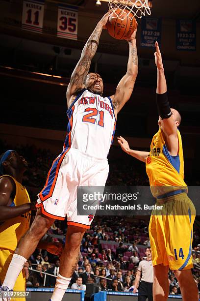 Wilson Chandler of the New York Knicks shoots against Maciej Lampe of the Maccabi Electra Tel Aviv on October 18, 2009 at Madison Square Garden in...