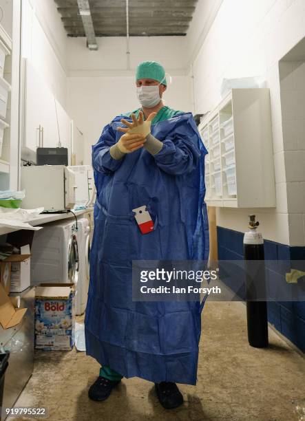 Equine Surgeon Phil Cramp gets dressed in a surgical gown before performing an operation at the Hambleton Equine Clinic on February 8, 2018 in...