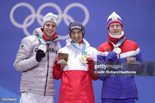 Silver medalist Andreas Wellinger of Germany, gold medalist Kamil Stoch of Poland and bronze medalist Robert Johansson of Norway celebrate during the...