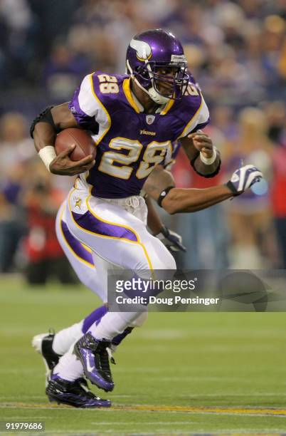 Running back Adrian Peterson of the Minnesota Vikings rushes the ball against the Baltimore Ravens during NFL action at Hubert H. Humphrey Metrodome...
