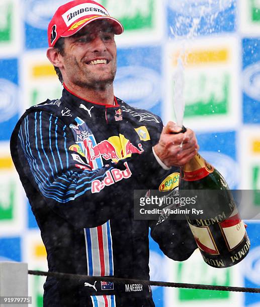 Mark Webber of Australia and Red Bull Racing celebrates on the podium after winning the Brazilian Formula One Grand Prix at the Interlagos Circuit on...