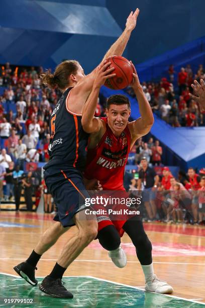 Jarrod Kenny of the Wildcats drives to the basket against Damon Heuir of the Taipans during the round 19 NBL match between the Perth Wildcats and the...