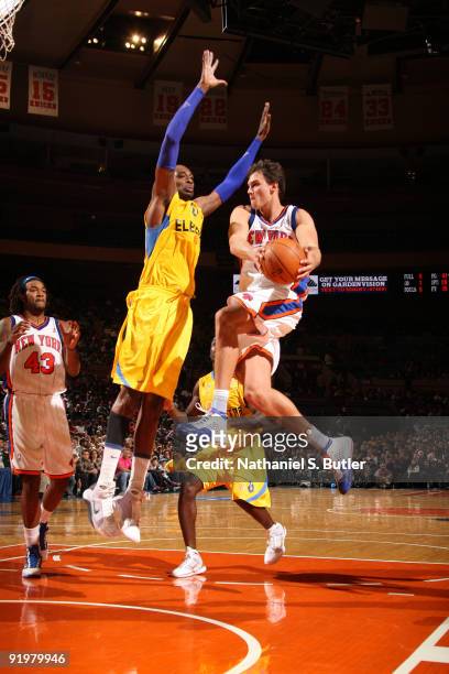 Danilo Gallinari of the New York Knicks shoots against Stepahne Lasme of the Maccabi Electra Tel Aviv on October 18, 2009 at Madison Square Garden in...