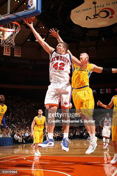 David Lee of the New York Knicks shoots against Maciej Lampe of the Maccabi Electra Tel Aviv on October 18, 2009 at Madison Square Garden in New York...