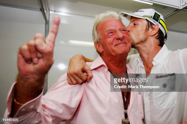 Jenson Button of Great Britain and Brawn GP celebrates with his father John Button after clinching the F1 World Drivers Championship during the...