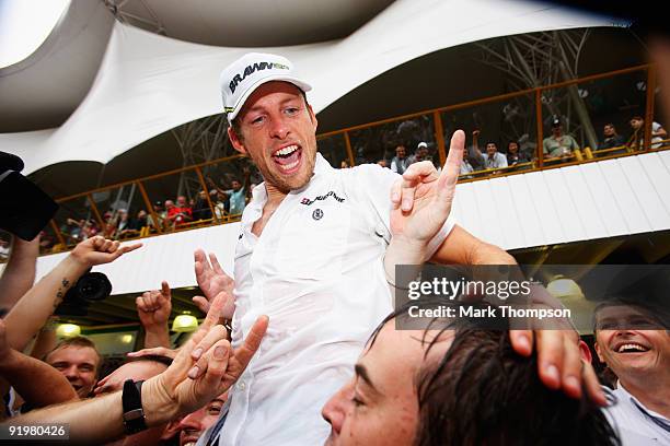 Jenson Button of Great Britain and Brawn GP celebrates clinching the F1 World Drivers Championship during the Brazilian Formula One Grand Prix at the...