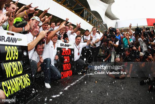 Jenson Button of Great Britain and Brawn GP celebrates with team mates as he wins the World Drivers Championship and Brawn GP win the Constructors...
