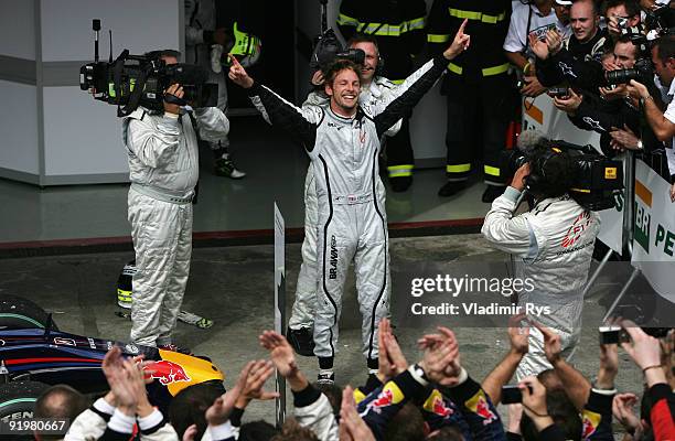 Jenson Button of Great Britain and Brawn GP celebrates in parc ferme after clinching the F1 World Drivers Championship during the Brazilian Formula...