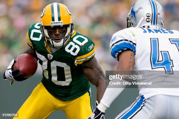 Donald Driver of the Green Bay Packers looks to get past William James of the Detroit Lions at Lambeau Field on October 18, 2009 in Green Bay,...