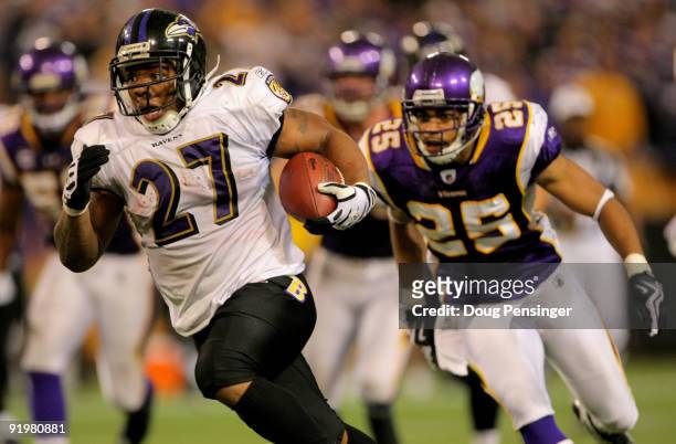 Running back Ray Rice of the Baltimore Ravens eludes Tyrell Johnson of the Minnesota Vikings as he rushes 33 yards for a fourth quarter touchdown...