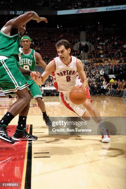 Jose Calderon of the Toronto Raptors drives to the net and gets around Kendrick Perkins of the Boston Celtics during a game on October 18, 2009 at...