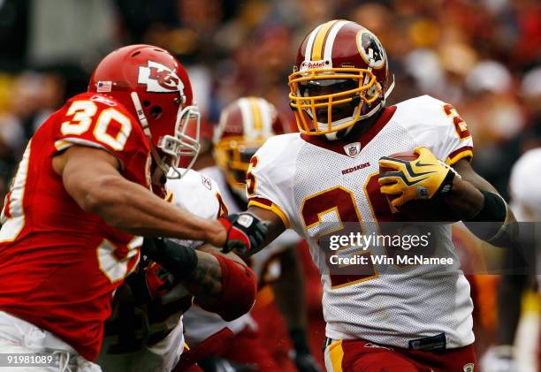 Mike Brown of the Kansas City Chiefs tackles Clinton Portis of the Washington Redskins during their game October 18, 2009 at FedEx Field in Landover,...