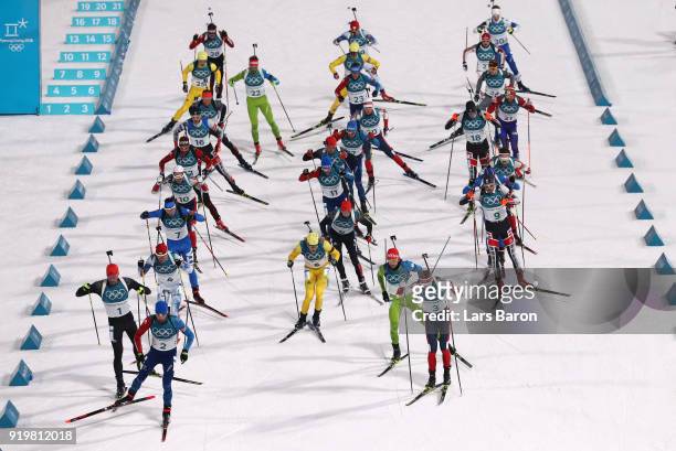 Biathletes set off at the start during the Men's 15km Mass Start Biathlon on day nine of the PyeongChang 2018 Winter Olympic Games at Alpensia...