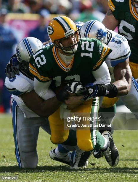 Aaron Rodgers of the Green Bay Packers is sacked by Turk McBride and Julian Peterson of Detroit Lions at Lambeau Field on October 18, 2009 in Green...