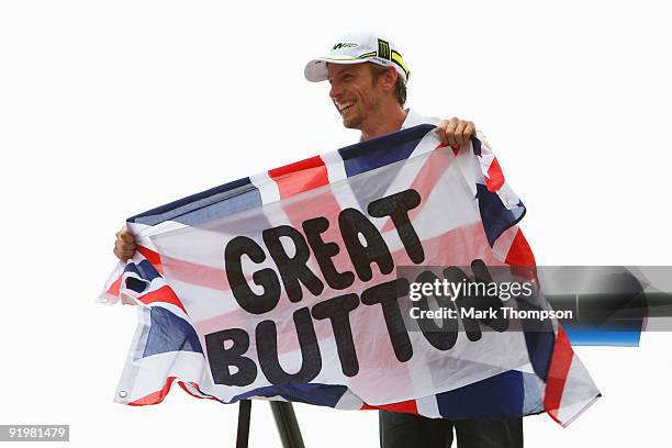 Jenson Button of Great Britain and Brawn GP celebrates clinching the F1 World Drivers Championship during the Brazilian Formula One Grand Prix at the...