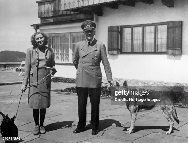 Eva Braun and Adolf Hitler, with their two dogs Wulf and Blondi at the Berghof, 1942. Found in the collection of State Central Military Museum,...