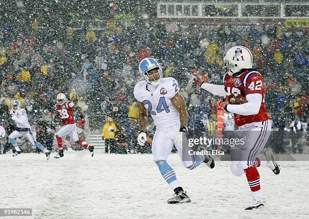 BenJarvis Green-Ellis of the New England Patriots carries the ball as Chris Hope of the Tennessee Titans defends on October 18, 2009 at Gillette...