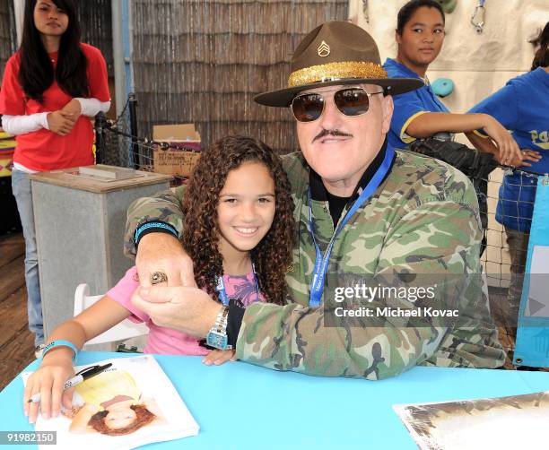 Actress Madison Pettis and Sgt. Slaughter sign autographs at the Mattel And Children's Hospital UCLA's "Party On The Pier" at Santa Monica Pier on...