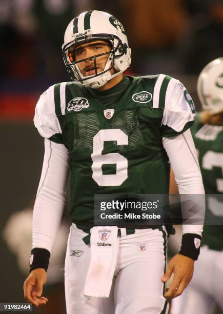 Ouarterback Mark Sanchez of the New York Jets walks off the field dejected after failing to convert on third down in overtime against the Buffalo...