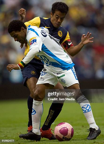 Pavel Pardo of America vies for the ball with Andres Olivera of Puebla during their match in the 2009 Opening tournament, the closing stage of the...